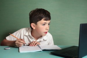 preteen handsome boy has online drawing lesson